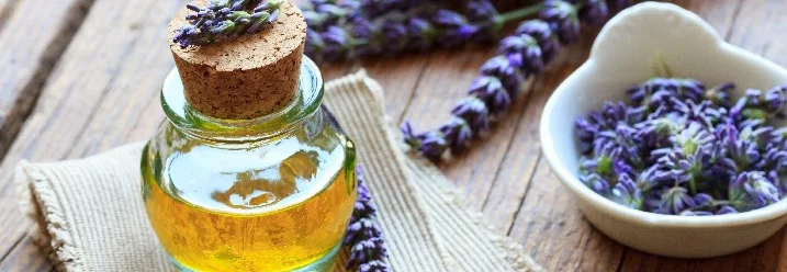 Glasflasche mit Lavendelöl und Lavendelblüten